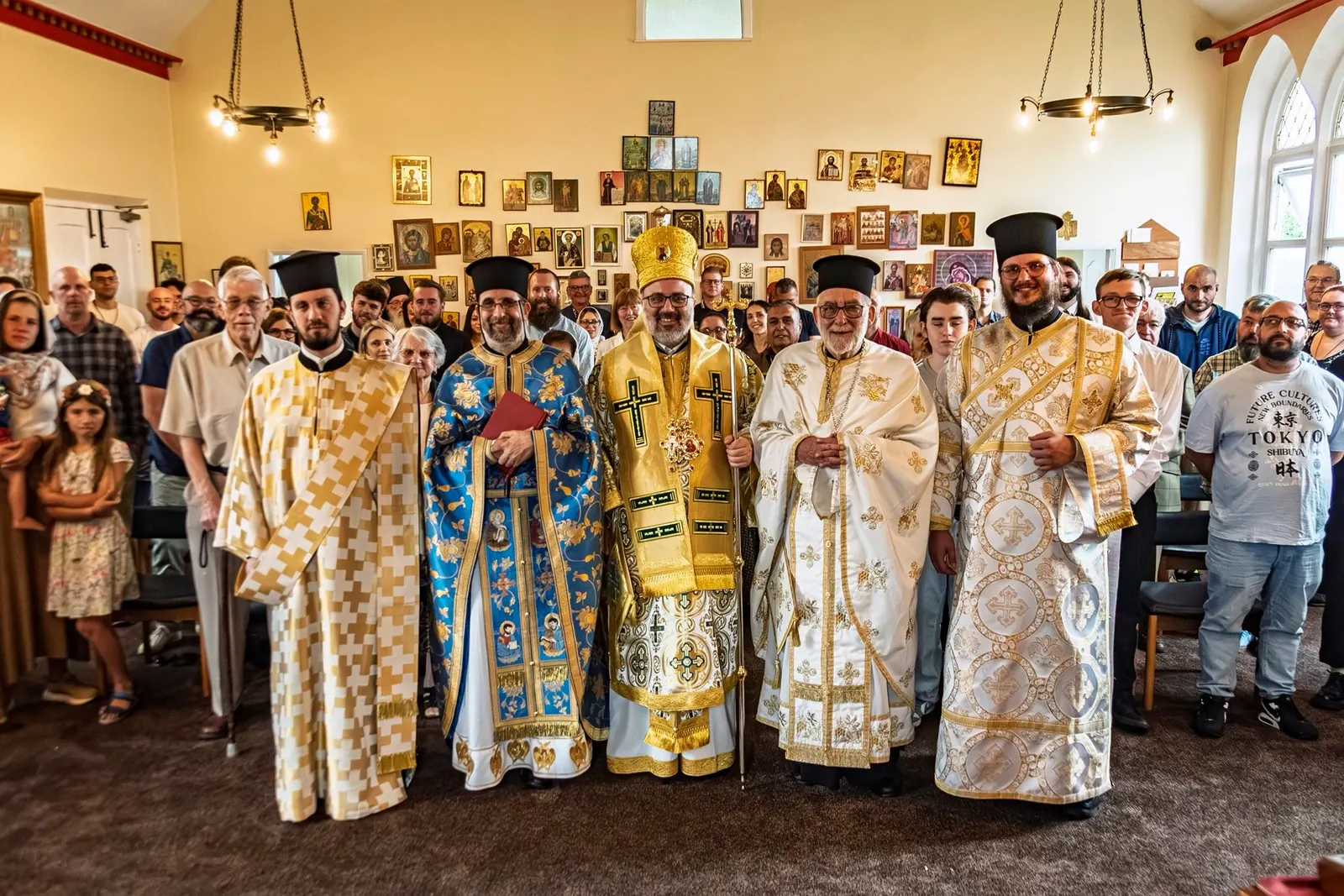The clergy and people of the parish gathered in church with the bishop, the icon wall behind them